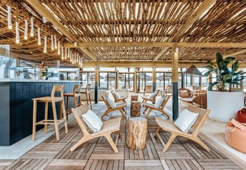 Überdachte Strandlounge im Friday Attitude mit Holzsitzen und Barbereich