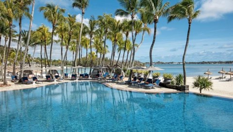 Poolanlage des Shangri-La Le Touessrok mit Sonnenliegen, Palmen und Strandblick